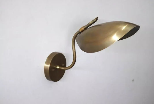 Elegant brass curved wall lamp with sleek design and upward-mounted shade